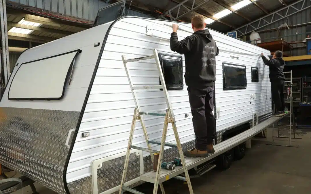 Caravan interior under construction: Technicians fitting the walls in a repair shop