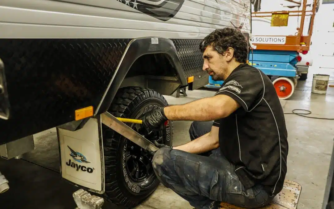 Caravan wheel maintenance: Technician inspects and repairs the tire