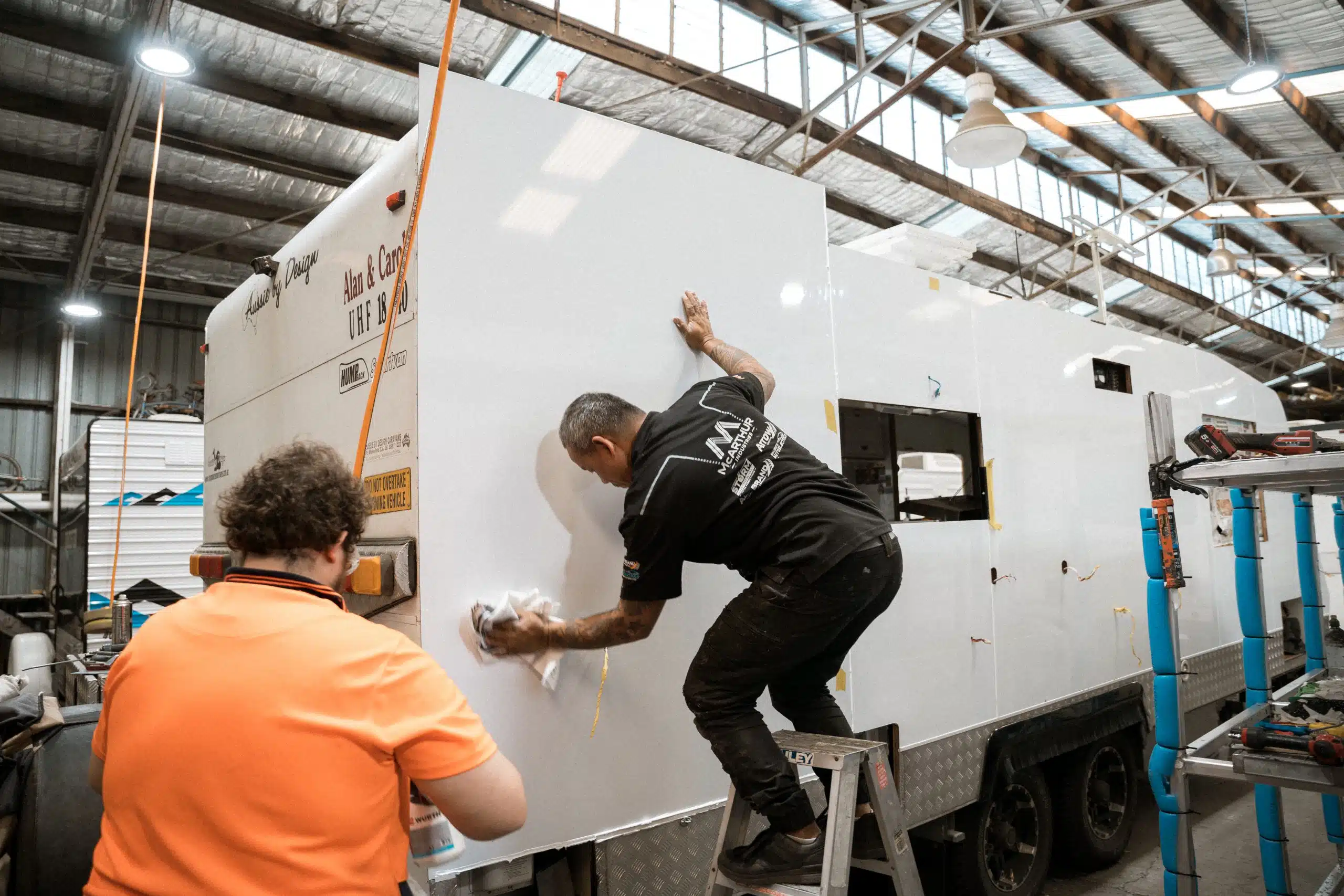 Caravan body repairs in progress: Technician fixes damage on the sidewall in a workshop